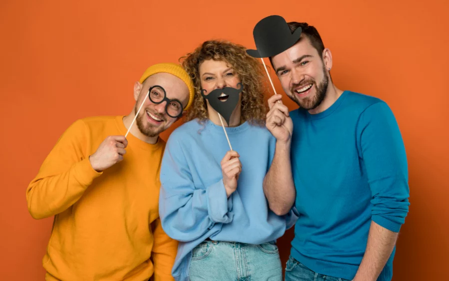 Eine Gruppe Freunde spielt mit Pappgegenständen.